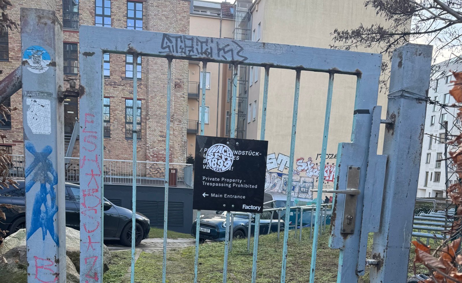 Locked gate in shadow of old Berlin Wall