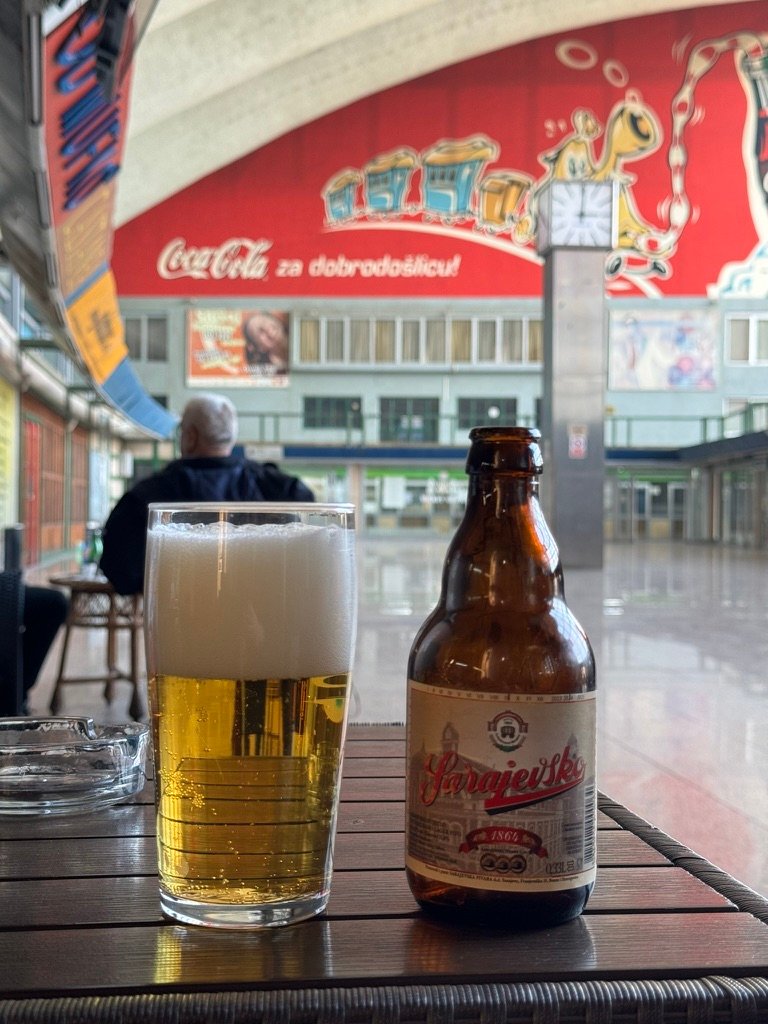 A local beer in front of a communisty mural at the train station the fuck out of here.